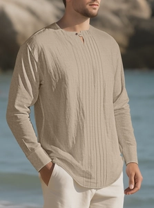 Detail of khaki cotton linen shirt with pleated texture and buttoned Henley collar