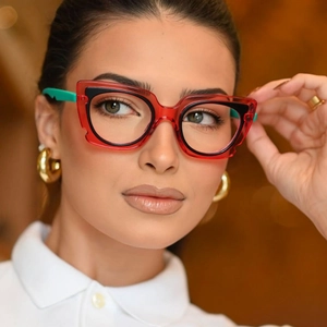 Colorful cat-eye eyeglass frames with bold red and green contrasting design