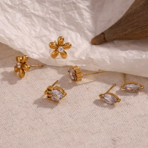 Close-up of 18K gold plated crown and flower stud earrings with marquise zircon stones