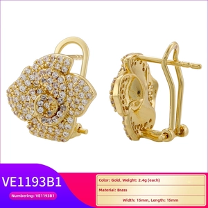 Detailed macro view of gold flower earrings in brass with micro-inlaid white zircons