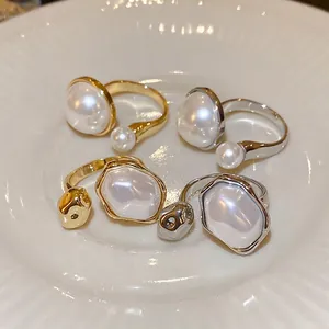 French style gold and silver irregular pearl open rings set for women on a ceramic plate