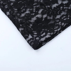 Détails de la dentelle noire délicate sur la robe à manches longues et épaules nues