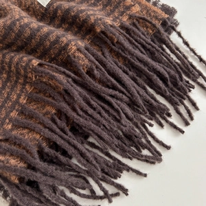 Thick warm checkered scarf with brown and orange stripes and fringe details