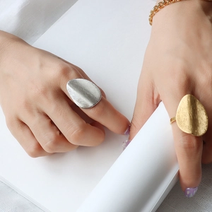 Irregular matte finish statement rings in gold and silver colors with brushed texture