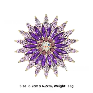 Detailed macro view of retro purple glass floral brooch with gold base and rhinestones