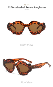 Close-up of tortoiseshell punk sunglasses with gold cross accent and tinted lenses