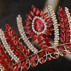 Detailed macro view of golden wedding crown featuring red marquise gems and clear rhinestones