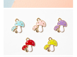 Detailed view of colorful enamel mushroom pendants with metal rings for jewelry making