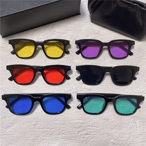 Flat lay of retro square sunglasses featuring six different vibrant lens color options