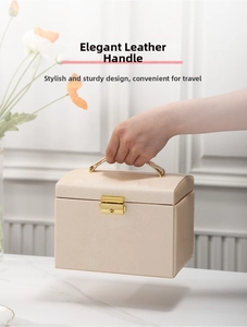 Detail of the elegant leather handle and gold metal clasp on the jewelry box