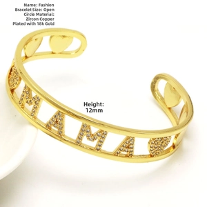 Detailed macro view of gold plated MAMA cuff bracelet with sparkling zircon heart inlay