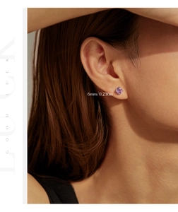 Detailed model shot of a 6mm purple round-cut stud earring with a four-prong silver setting