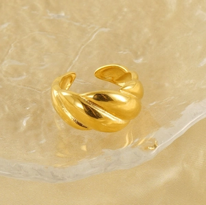 Detailed close-up of 18k gold plated croissant ring on elegant satin and glass tray