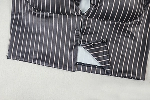 Detailed view of the multi-row hook closure and striped fabric on this street style top