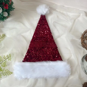 Detail of red Christmas hat with shiny sequins and white plush faux fur trim
