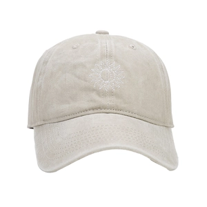 Close-up of a vintage washed beige cotton baseball cap with white sunflower embroidery