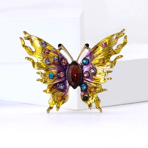 Close-up of luxury alloy butterfly brooch with colorful enamel and multi-gemstones