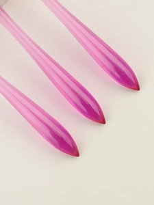 Macro view of three pink gradient acrylic nail brush handles with pointed gourd shape