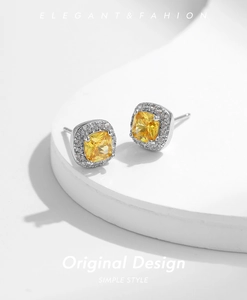 Detailed macro view of square halo stud earrings with yellow cushion-cut center stone