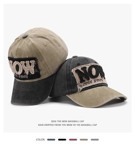 Detailed close-up of vintage washed cotton baseball caps with NOW embroidery and distressed edges
