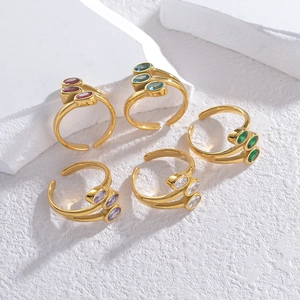 Five-piece set of gold vintage oval zircon rings with colorful stones on white stone base