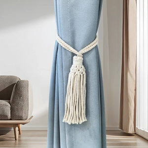 Hand-woven cotton rope curtain tieback with long tassels in a boho style for home decor