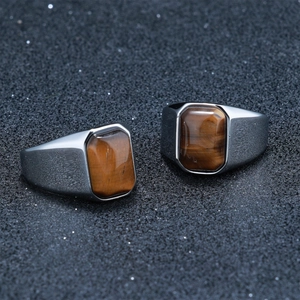 Macro detail of men's stainless steel signet rings with square tiger eye stone insets