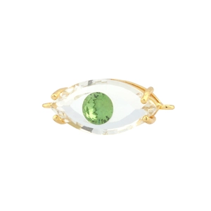 Detailed view of evil eye gold charm with faceted clear and green zircon stones