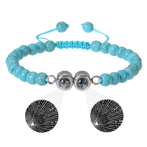 Detailed view of blue stone beads with a double nano projection stone showing I Love You