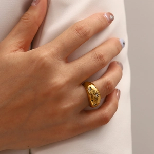 Vintage gold starburst ring with colorful zircon gemstones worn on a hand