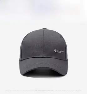 Front view of a dark grey cotton baseball cap with a silver metal shield logo detail