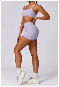 Detail view of lavender yoga set showing cross back bra and high waist fitness shorts