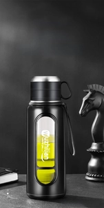 Detail view of double-walled glass bottle with tea infuser and built-in carrying strap