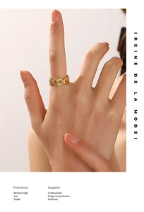 Fashionable 18K gold plated evil eye ring with beaded texture shown on finger