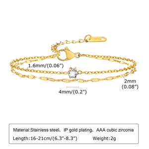 Detail of golden stainless steel double layer bracelet with cubic zirconia pendant