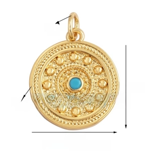 Macro view of gold-plated celestial pendant with blue gemstone and beaded relief edges
