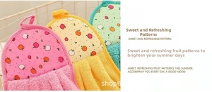 Macro shot of soft coral fleece hand towels with fruit patterns and hanging loops