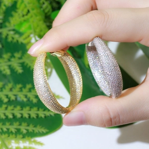 Minimalist gold and silver hoop earrings with pavé micro-set cubic zirconia crystals