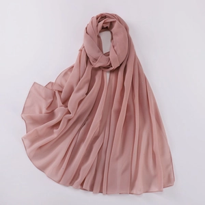 Detail showing soft pink chiffon fabric texture and sparkling rhinestones on the shawl
