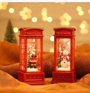 Close-up of red Christmas telephone booth lanterns with Santa and snowman figurines