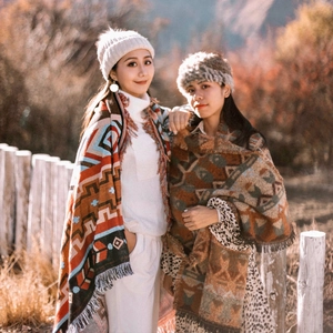 Close-up of bohemian tribal pattern camping blankets with fringe and warm knit texture
