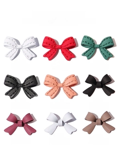 Selection of 3D bow nail art charms in matte and stitched textures with various colors