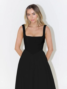 Detailed close-up showing the elegant square neckline and tailored waist of a black dress