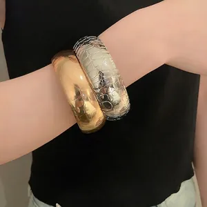 Textured gold and silver metal bangles with crocodile pattern embossing for women
