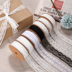 Assorted white and black lace ribbon rolls with heart patterns for gift wrapping