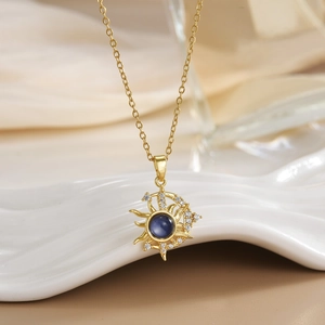 Close-up of gold-plated sun and moon necklace with dark blue opal and micro-set zircon