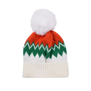 Detail of red and green knitted winter beanie with a white faux fur pompom and ribbed cuff