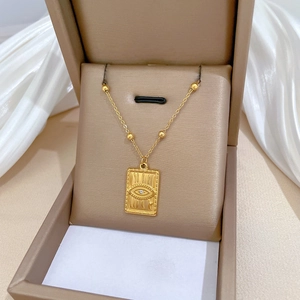 Minimalist titanium steel gold evil eye pendant necklace in a jewelry box