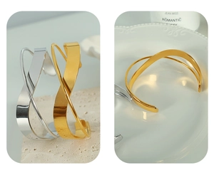 Close-up of gold and silver twisted minimalist open bracelets on stone and ceramic surfaces