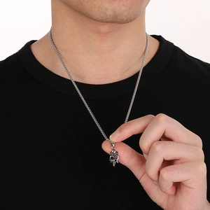Detail of silver stainless steel cross pendant with red accents on box chain for men